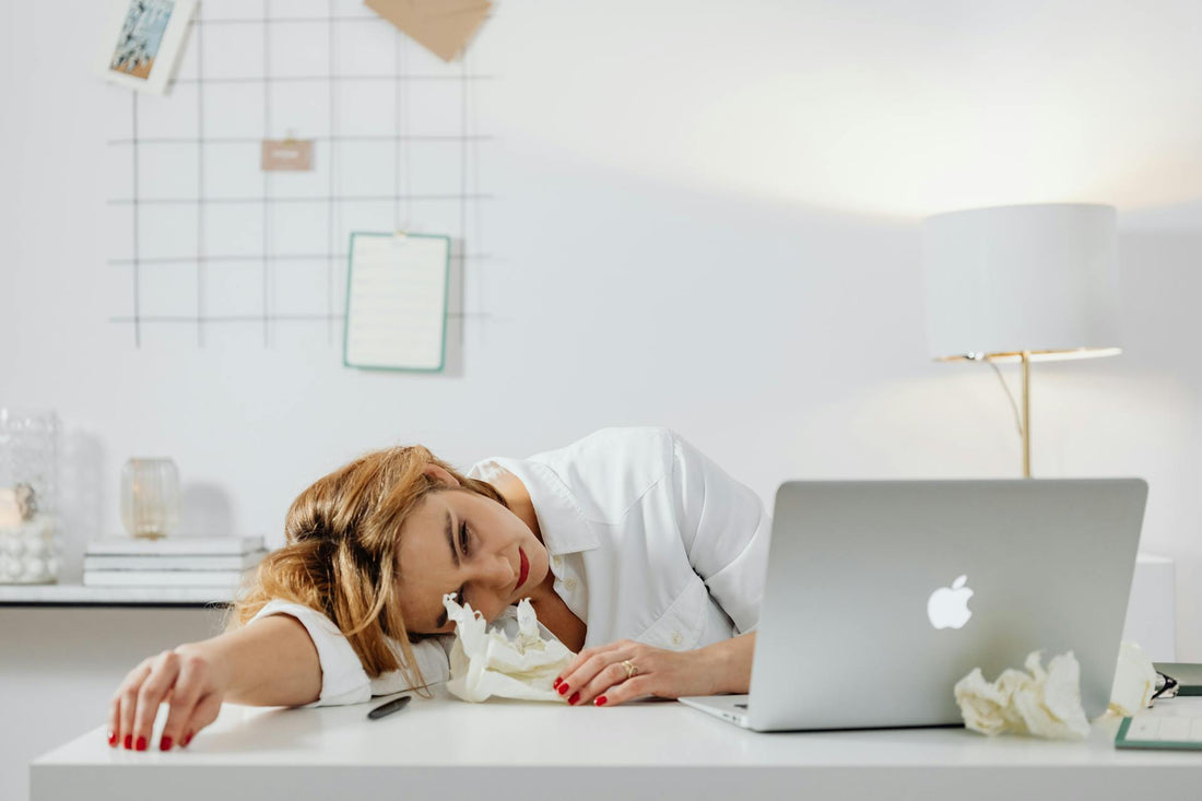 Lady with chronic fatigue laying exhausted on her desk